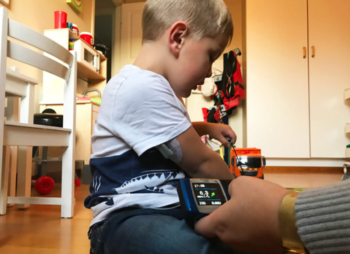Theo Stenlundh leker och mamma Emelie Stenludh tittar på hans blodsockervärde. Diabetes typ 1 barn